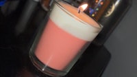 a pink candle sitting on top of a table