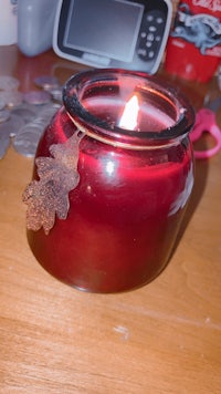 a red candle on a wooden table